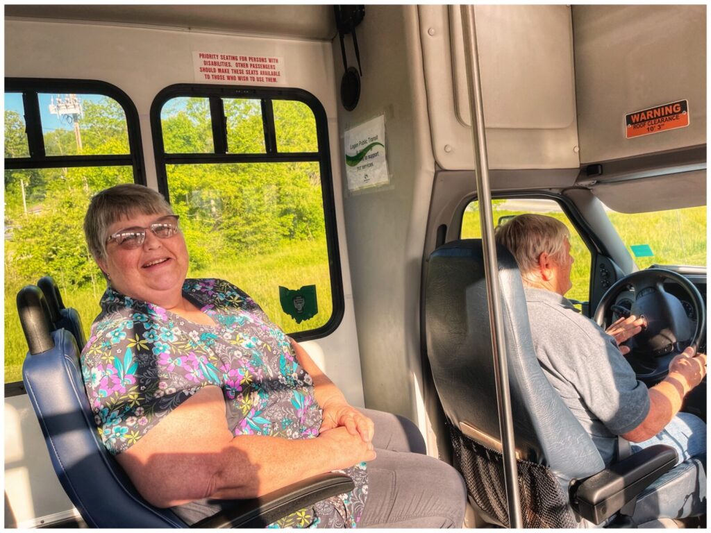 Woman smiling on Logan Transit Bus